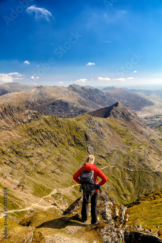 Young female hiker relaxing on mountain summit Wales