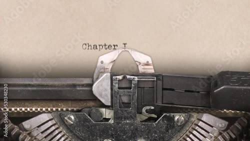 Old retro typewriter with sheet of paper. Close up. Words. Writing text Chapter I. Machine sounds.