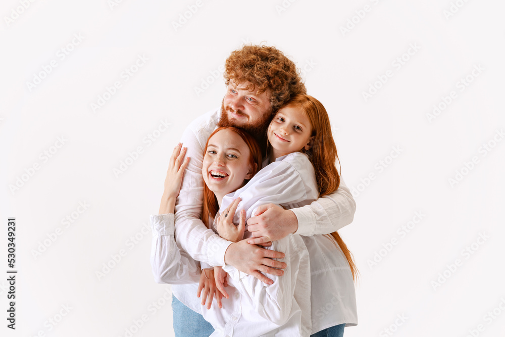 Portrait of happy family, redhaired parents and kid in casual wear look at camera with smile, have good family relationship. Portrait of happy family, redhaired parents and kid in casual wear look at camera with smile, have good family relationship.