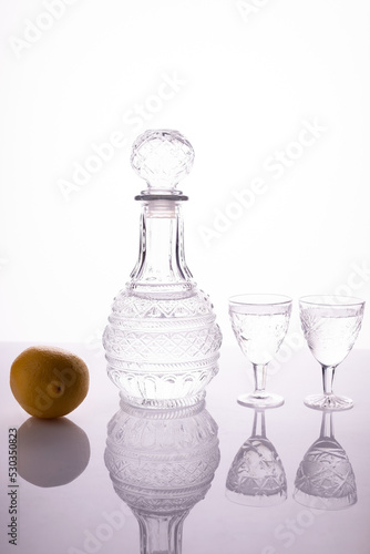 decanter with glasses of vodka on a white background alcohol shot