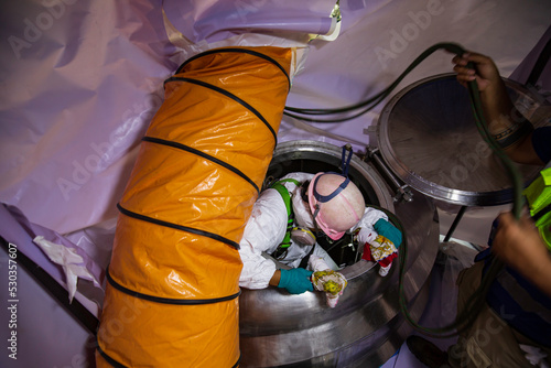 Top view male worker climb down rope access rescue the stairs into the tank stainless chemical area confined space safety