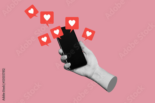 Female hand holds mobile phone with black blank screen with like symbols from social networks isolated on pink color background. 3d trendy collage in magazine style. Contemporary art. Modern design