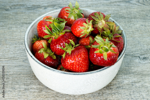 Red strawberry organic fruits in a bowl. Fresh berries fruit snack.