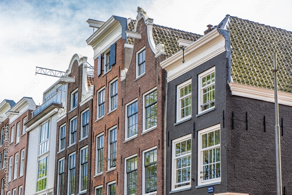 Details and facades of Amsterdam characteristic brick construction of residential building in Amsterdam School style. High quality photo