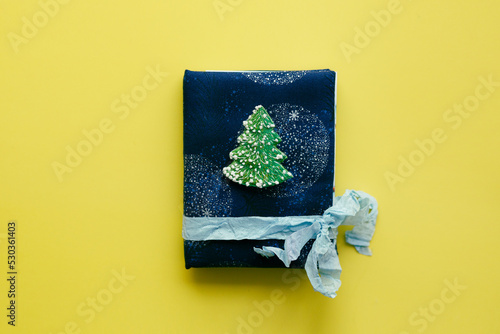 Handmade mini album or notebook in a soft textile cover and a Christmas tree bro Fototapet