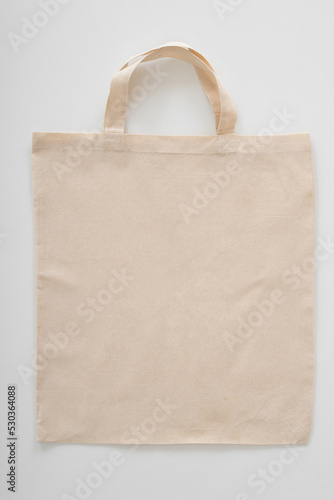 Blank Eco Friendly Beige Colour Fashion Canvas Tote Bag Isolated on White Background. Empty Reusable Bag for Groceries. Clear Shopping Bag. Design Template for Mock-up. Front View. Studio Photography.