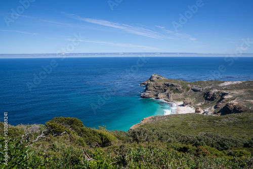 A spectacular view of the blue sea, rocky headland, and Dias beach at Cape Point in the Table Mountain National Park. © Tekweni