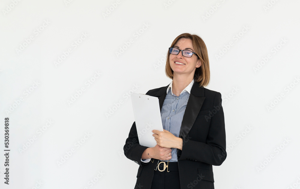 Portrait of attractive and smiling business woman with crossed arms standing in the office Portrait of attractive and smiling business woman with crossed arms standing in the office