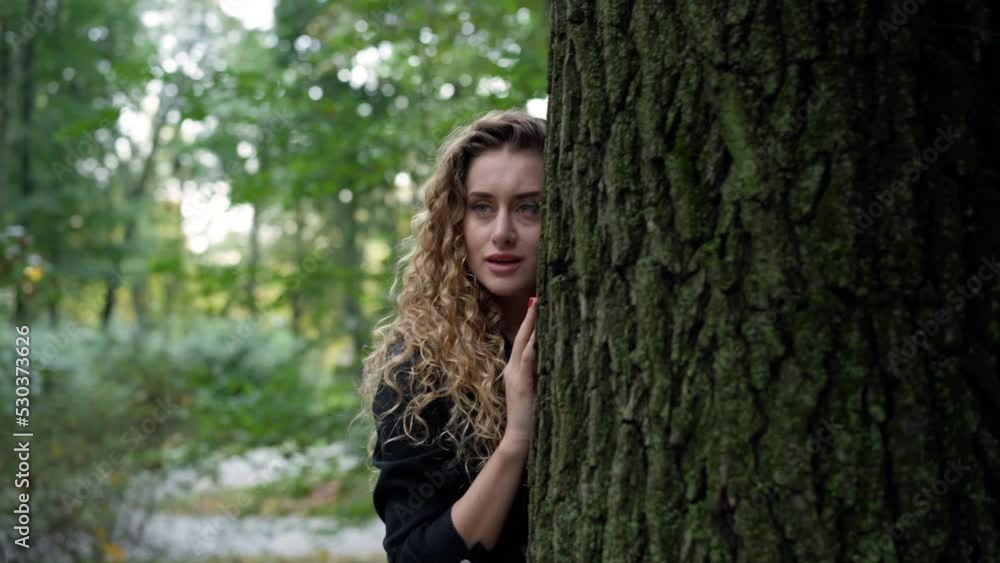 Panning around tree with beautiful woman hugging trunk. Calm confident young Caucasian lady enjoying tranquility in summer park outdoors. Connection with nature concept Panning around tree with beautiful woman hugging trunk. Calm confident young Caucasian lady enjoying tranquility in summer park outdoors. Connection with nature concept