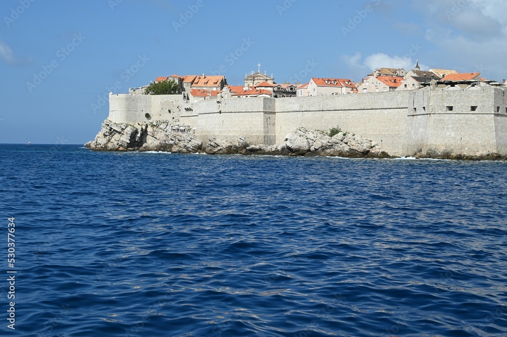 The outer walls of the old walled town of Dubrovnik at Dalmatia in Croatia from the sea. The outer walls of the old walled town of Dubrovnik at Dalmatia in Croatia from the sea.