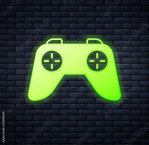 Glowing neon Game controller or joystick for game console icon isolated on brick wall background. Vector