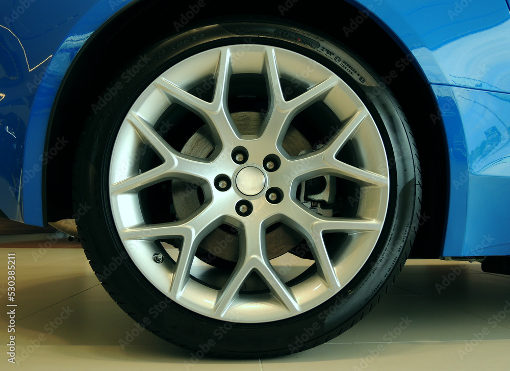 Ultralight alloy wheel mounted on a sports car closeup stock photo