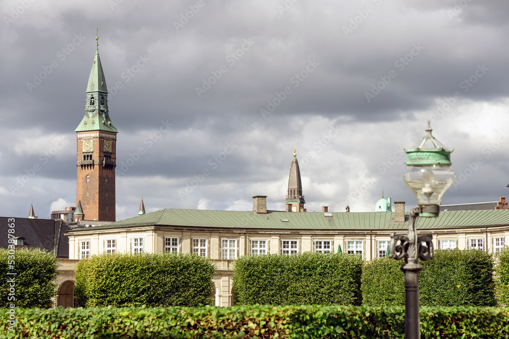 Fototapeta premium City towers in central Copenhagen against the rainy cloudy sky.