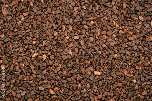 Macro background and texture of chicory granules often used with or as a substitute for coffee, made from the root of the chicory plant, Cichorium intybus, also known as endive.