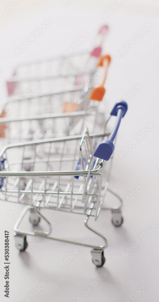 Vertical video of empty shopping carts on white background Vertical video of empty shopping carts on white background