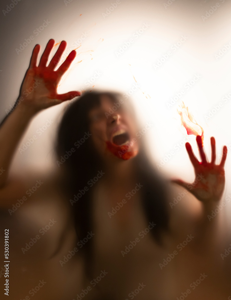 Shadowy figure with blood behind glass - horror background