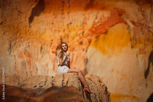 A beautiful young woman walks along a stream in the tropics. Vietnam Mui Ne. Blonde in the tropics