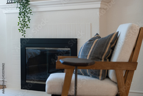 Living room scene detail of fireplace and side chair.