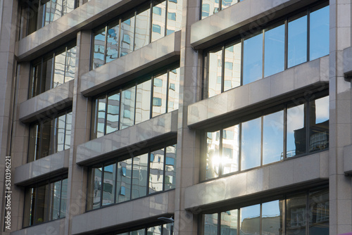 modern glass facade exterior mirroring sky reflections