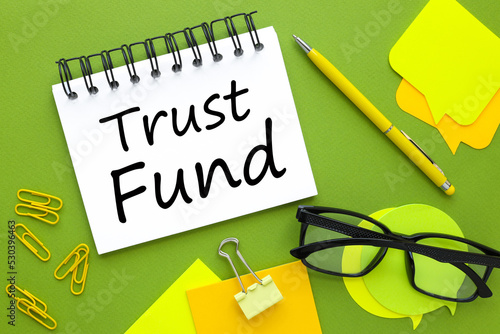 business concept. TRUST FUND, text on paper. green background