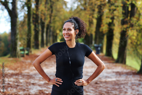 positive woman stretching outdoors preparing for exercise in sportswear