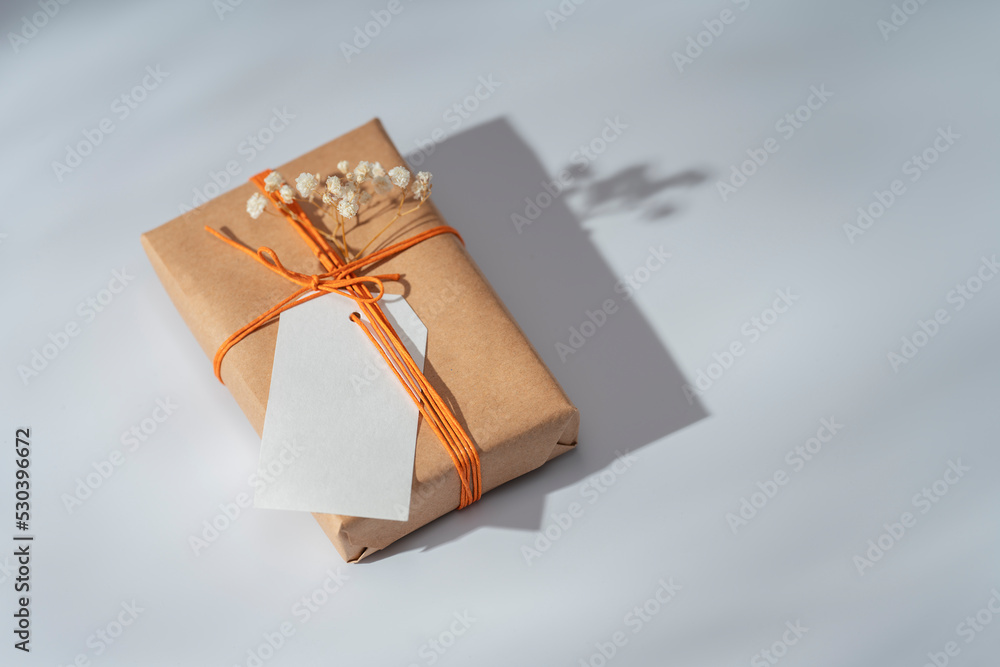 Kraft gift box with orange thread and labels for inscriptions on a ...