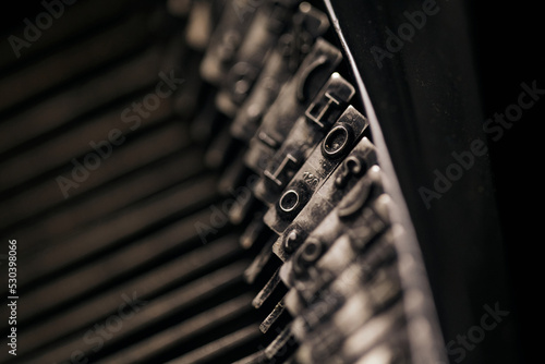 Closeup of old typewriter plates strikers strykers with letters and symbols for typing.