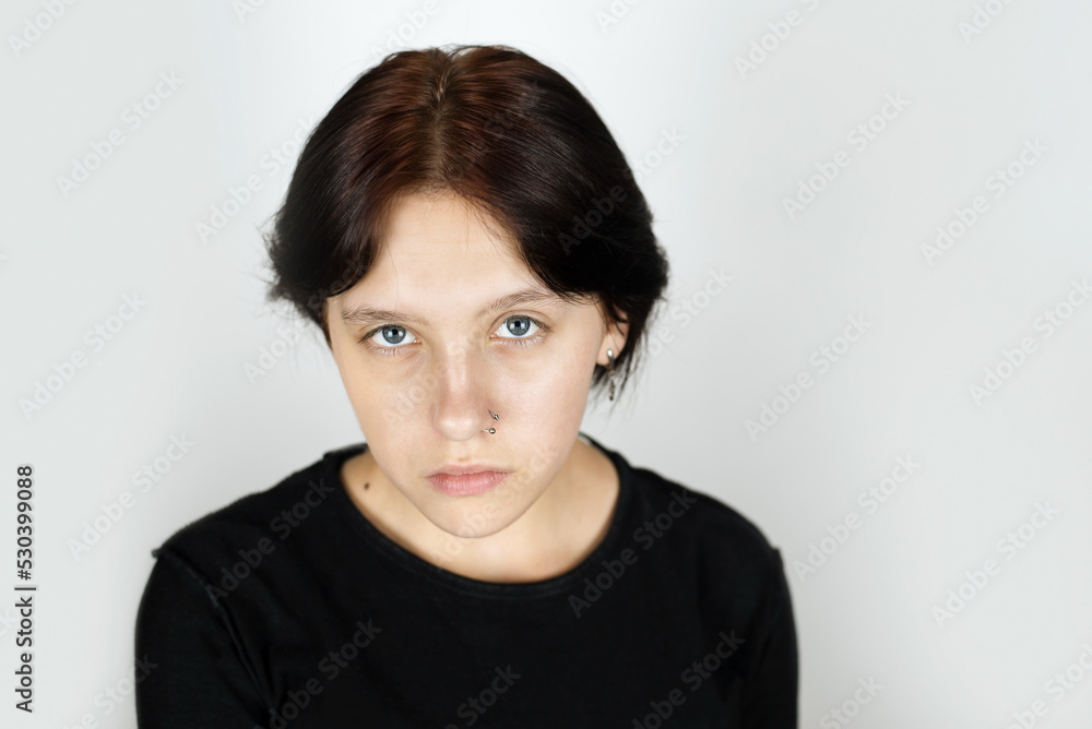 A beautiful sad teenage girl on a light background, the girl misses her childhood when everything was simple and clear, now she has a difficult relationship with teachers and classmates A beautiful sad teenage girl on a light background, the girl misses her childhood when everything was simple and clear, now she has a difficult relationship with teachers and classmates