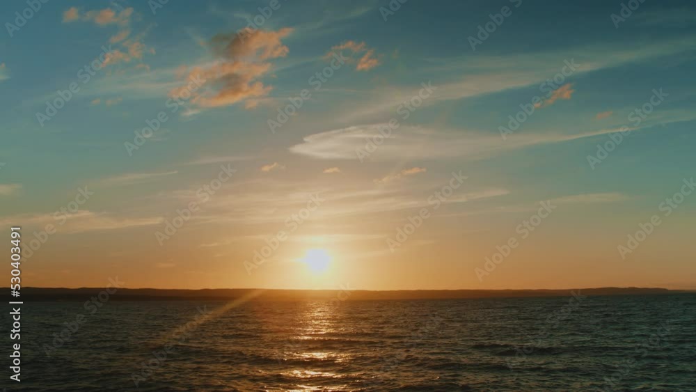 Seascape with beautiful sunset and clouds in the sky. Time lapse of majestic sunset landscape. Amazing nature light of cloudy sky and clouds receding from rolling colorful sunset dark clouds Seascape with beautiful sunset and clouds in the sky. Time lapse of majestic sunset landscape. Amazing nature light of cloudy sky and clouds receding from rolling colorful sunset dark clouds