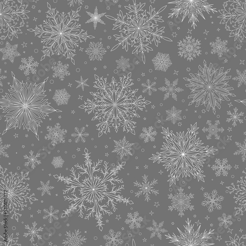 Seamless pattern with complex big and small Christmas snowflakes in gray colors. Winter background with falling snow