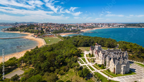Magdalena Palace in Santander Spain with aerial view of the peninsula and the city with sunny beach in summer.