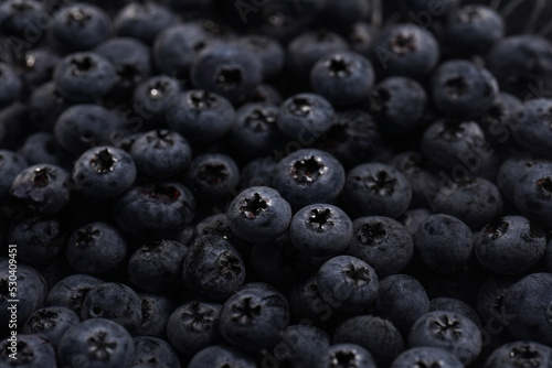 a heap of fresh ripe wet blueberries under water filling the frame, selective focus, top view, background