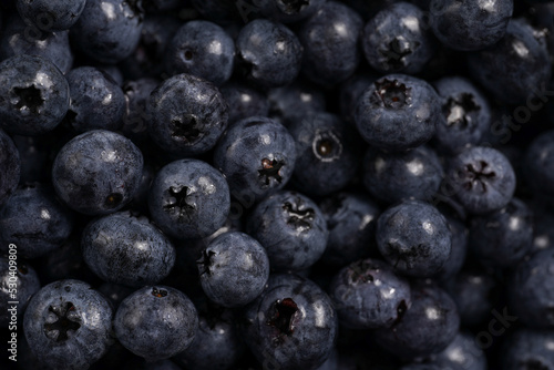 a heap of fresh ripe wet blueberries filling the frame, selective focus, top view, background