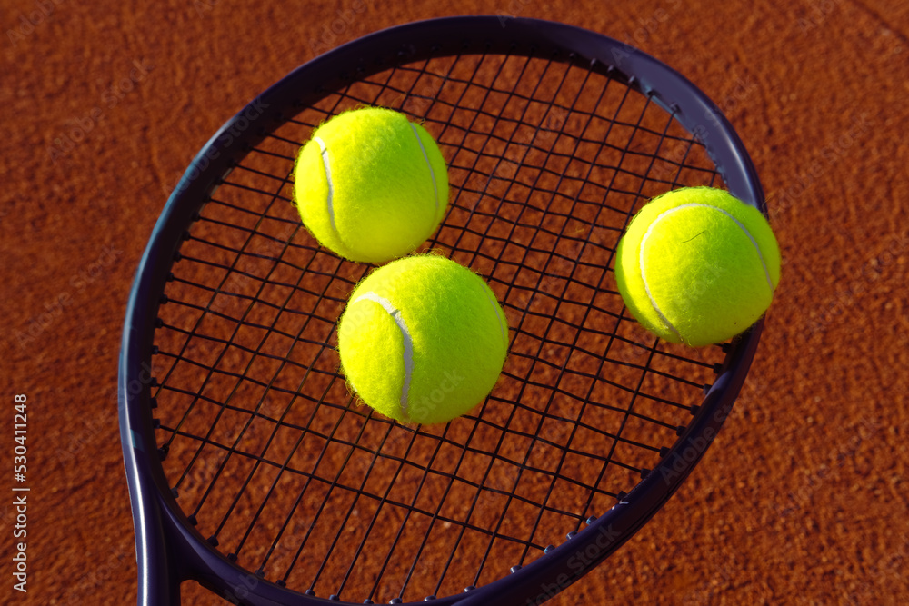 Tennis balls on a racket. Summer tennis training