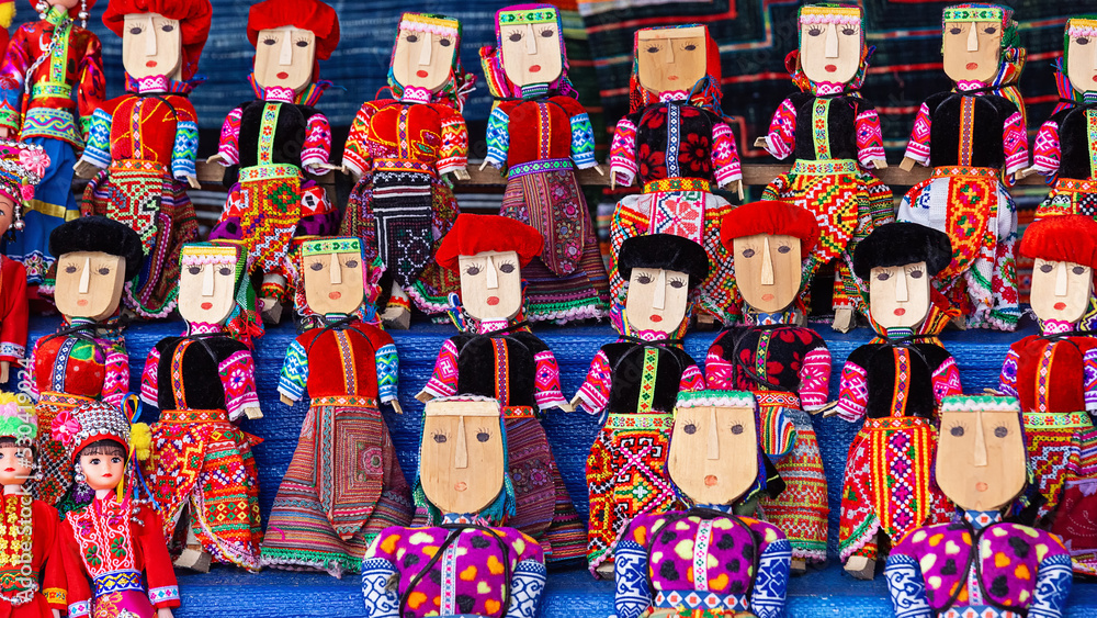 Traditional souvenirs of Vietnam. Wooden puppets in traditional clothes.