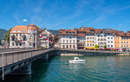 Solothurn, Switzerland - July 12, 2022: A boat under the bridge on the river Aare in Solothurn