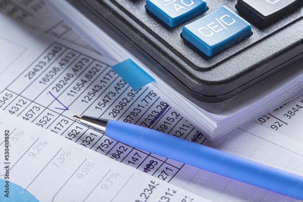 Accounting document with pen, money, coins and checking financial chart. Concept of banking, financial report and financial audit. Accounting document with pen, money, coins and checking financial chart. Concept of banking, financial report and financial audit.