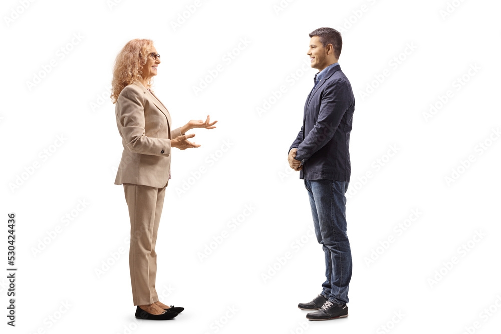 Full length profile shot of a mature woman talking to a young man Full length profile shot of a mature woman talking to a young man