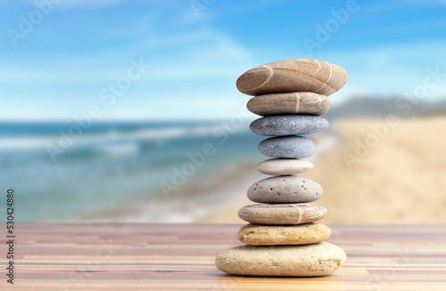 Stacked pebbles to make shape of hourglass as a symbol of time management. Concept of meditation, slow down and controlling time.