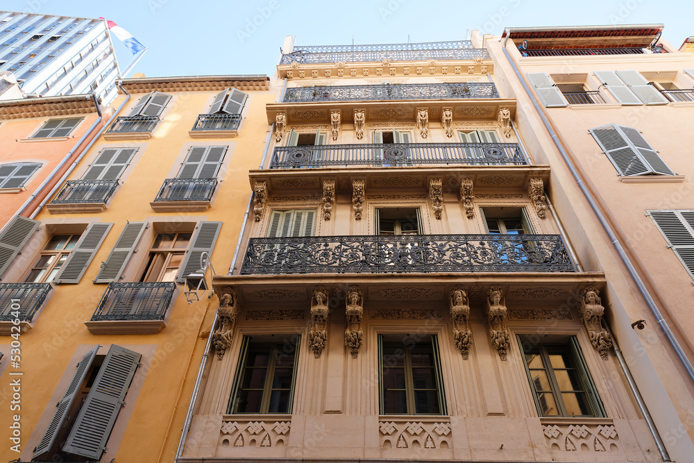 Looking up at the architectural details of an old apartment building in Toulon, France. Looking up at the architectural details of an old apartment building in Toulon, France.