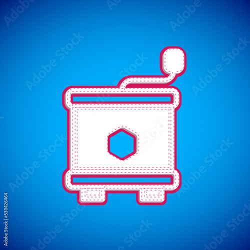 White Honey extractor icon isolated on blue background. Mechanical device for honey extraction from honeycombs. Vector