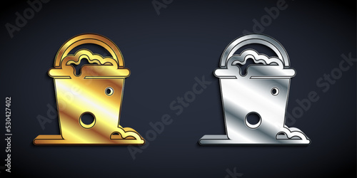 Gold and silver Bucket with foam and bubbles icon isolated on black background. Cleaning service concept. Long shadow style. Vector