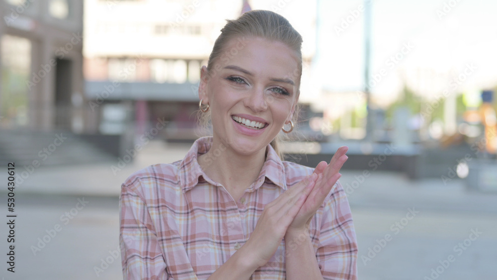 Young Woman Clapping in Appreciation Outdoor