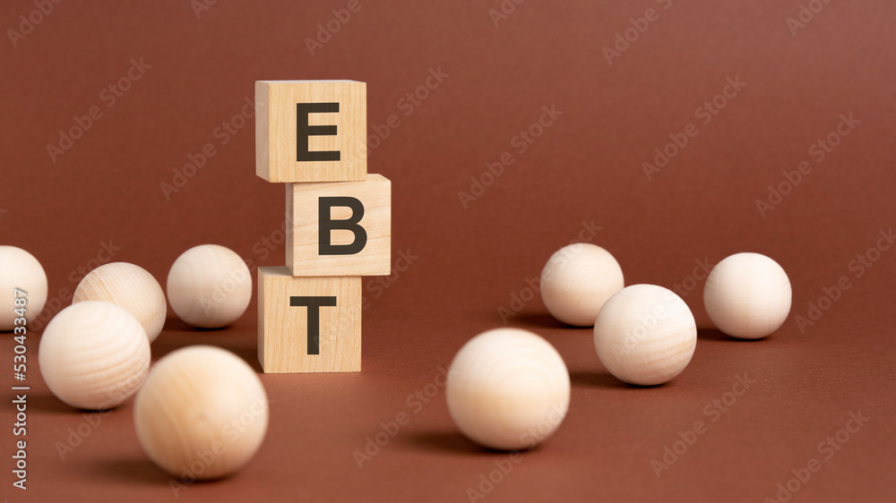 wooden cubes block with text ebt, brown background wooden cubes block with text ebt, brown background