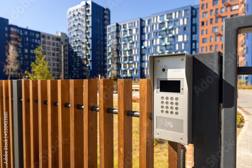 Electronic lock with buttons and intercom on the fence gate, safety device.	 photo