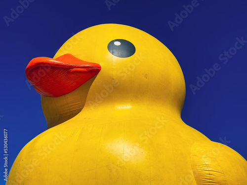 Giant yellow rubber duck against a blue sky