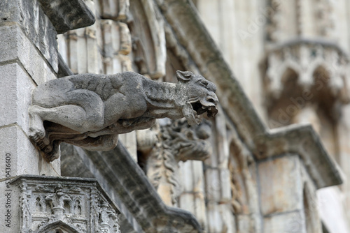 Photographie Monstrous statue with almost human features called gargoyle on the historic buil