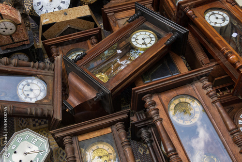Group of vintage wooden wall clocks lying
