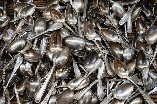 Heap of aged silver spoons © Oligo