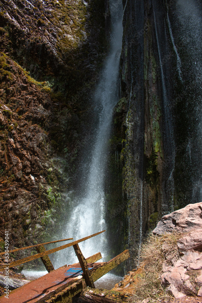 Poc poc waterfall with wooden footbridge, located in Chinchero, in the